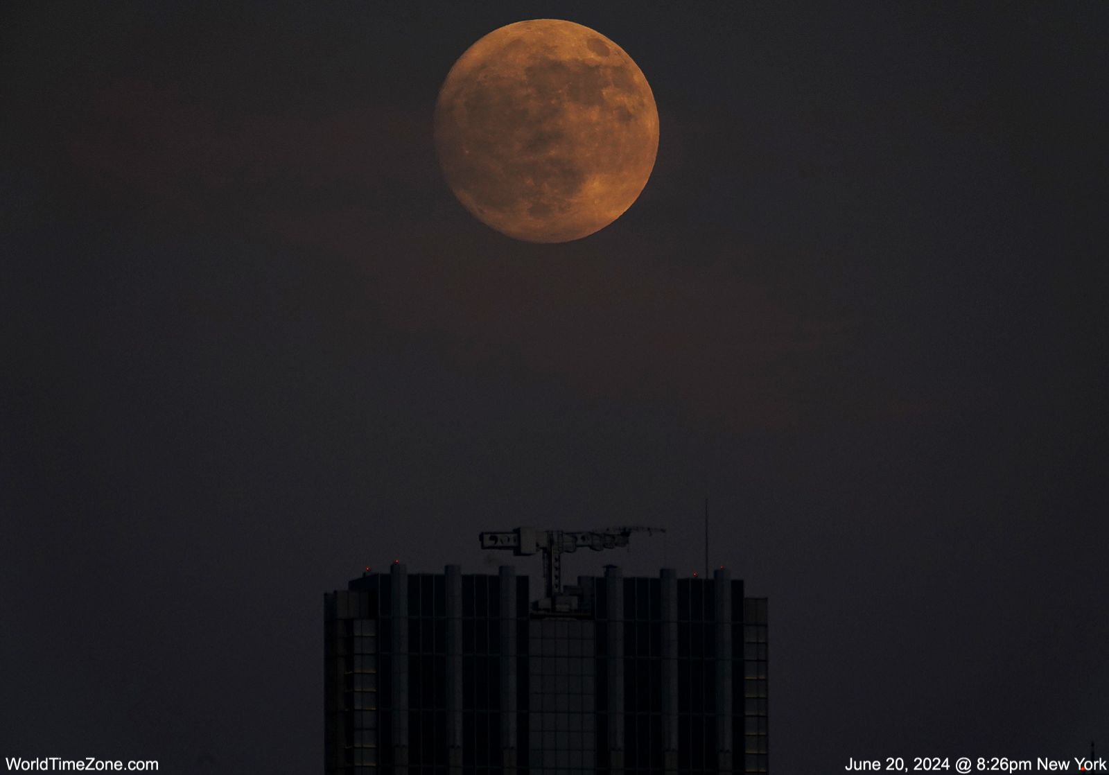Community photo entitled Summer Solstice Moon rises above Manhattan buildings in New York City. by Alexander Krivenyshev on 06/20/2024 at Manhattan, New York