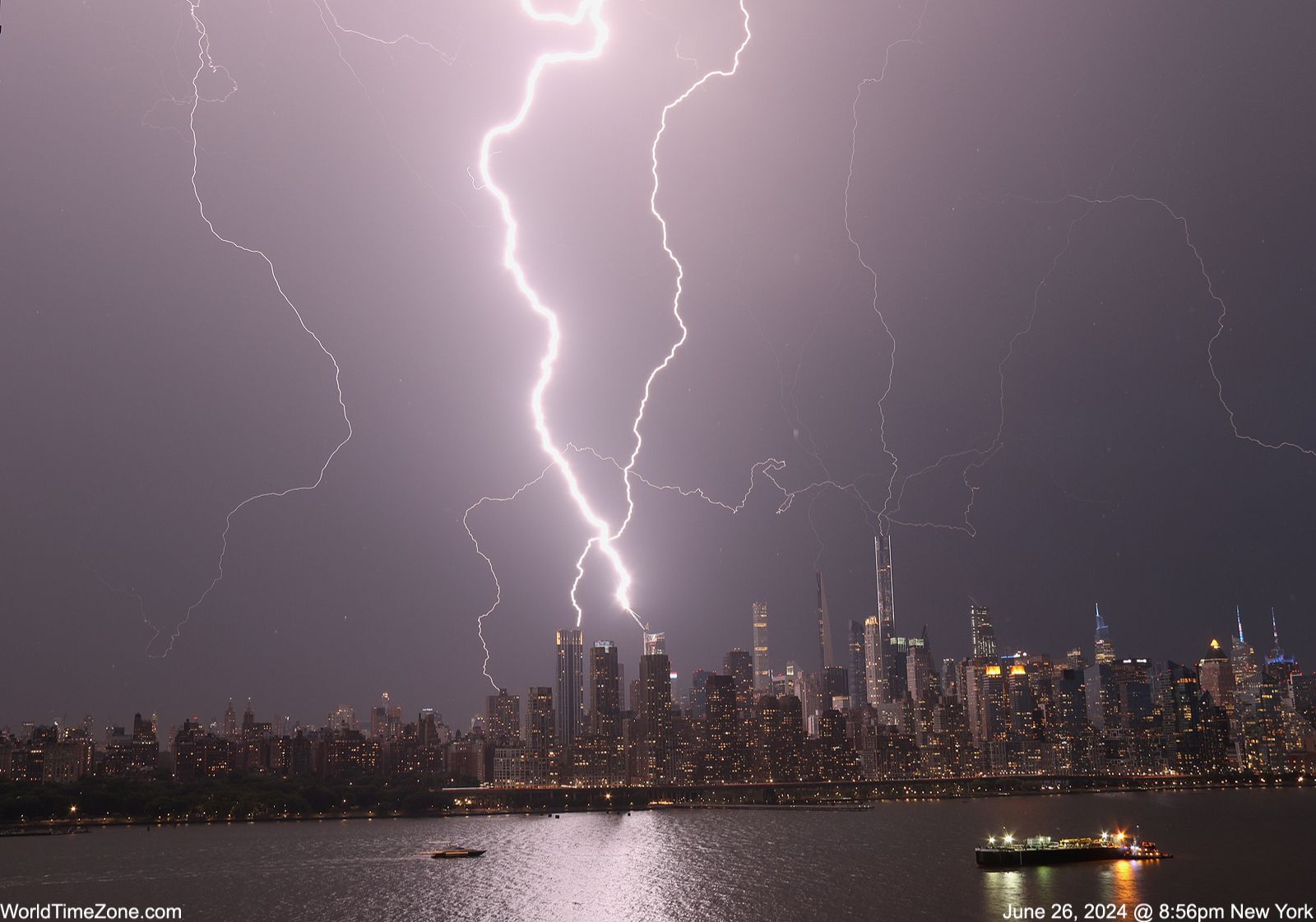 Community photo entitled Multiple lightning strikes shooting across the Manhattan skyline by Alexander Krivenyshev on 06/26/2024 at Manhattan, New York