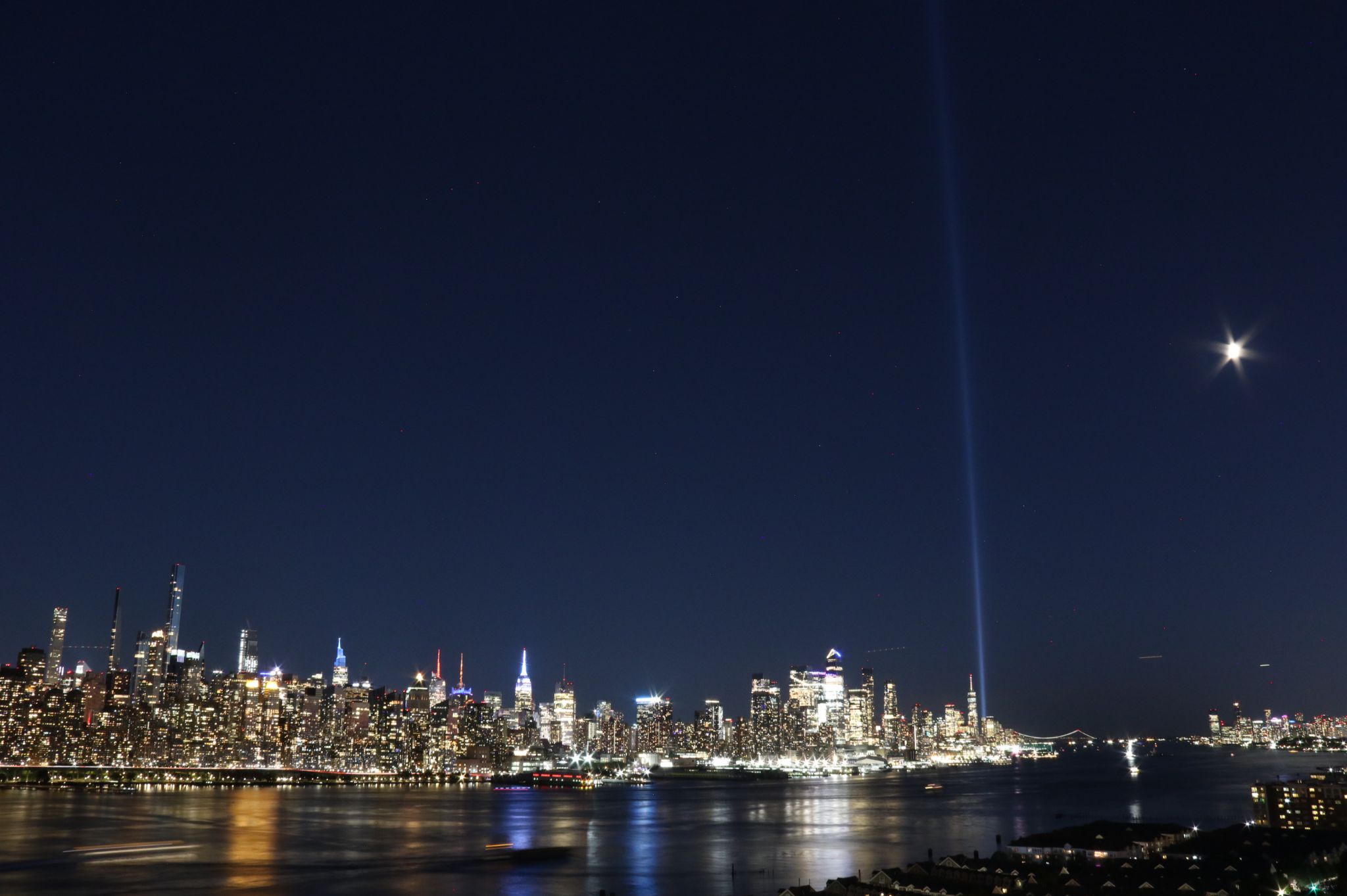 Community photo entitled 9/11 "Tribute in Light" and first quarter Moon light above New York by Alexander Krivenyshev on 09/10/2024 at Manhattan, New York