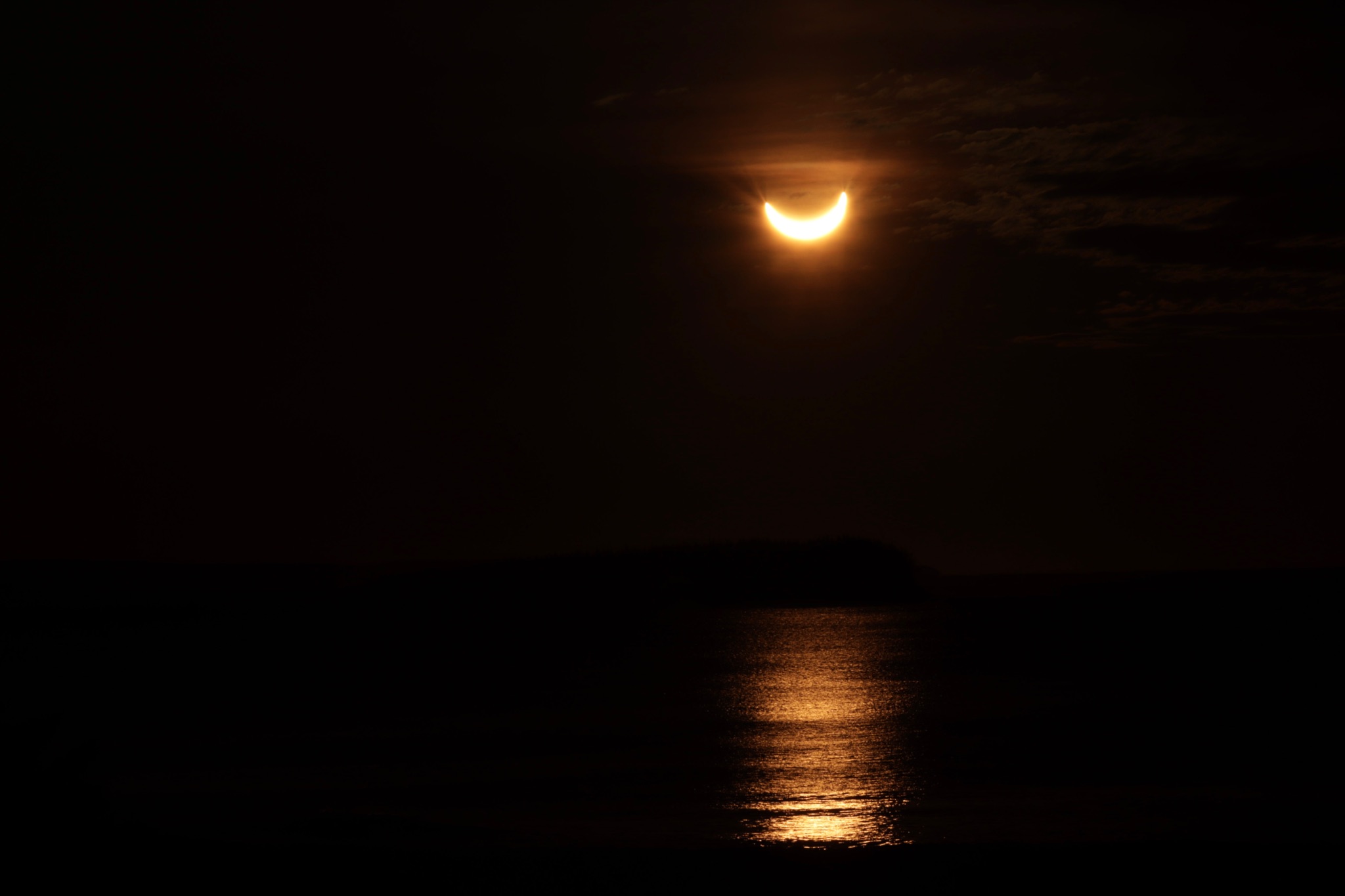 Community photo entitled Sunrise partial eclipse over the Atlantic Ocean. by David Chapman on 03/29/2025 at Seaforth, Nova Scotia