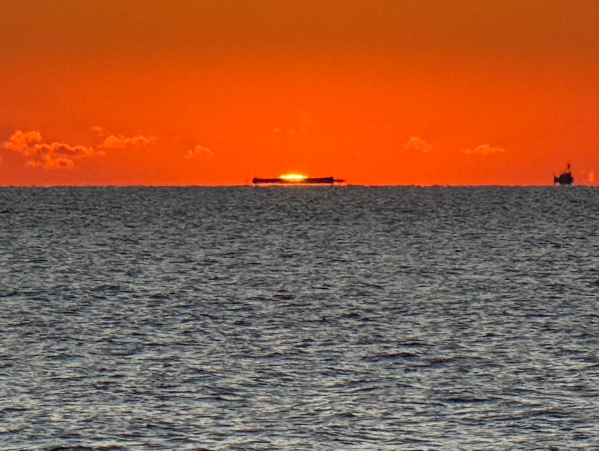 Community photo entitled Green Flash with Barge by Nancy Case on 11/01/2025 at Indian Rocks Beach, Florida
